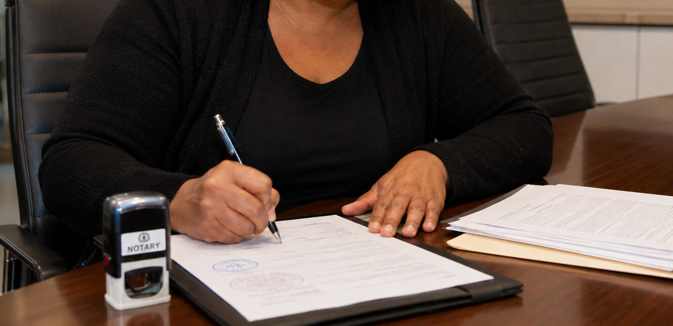 Notary Signing Hands of a notary signing documents